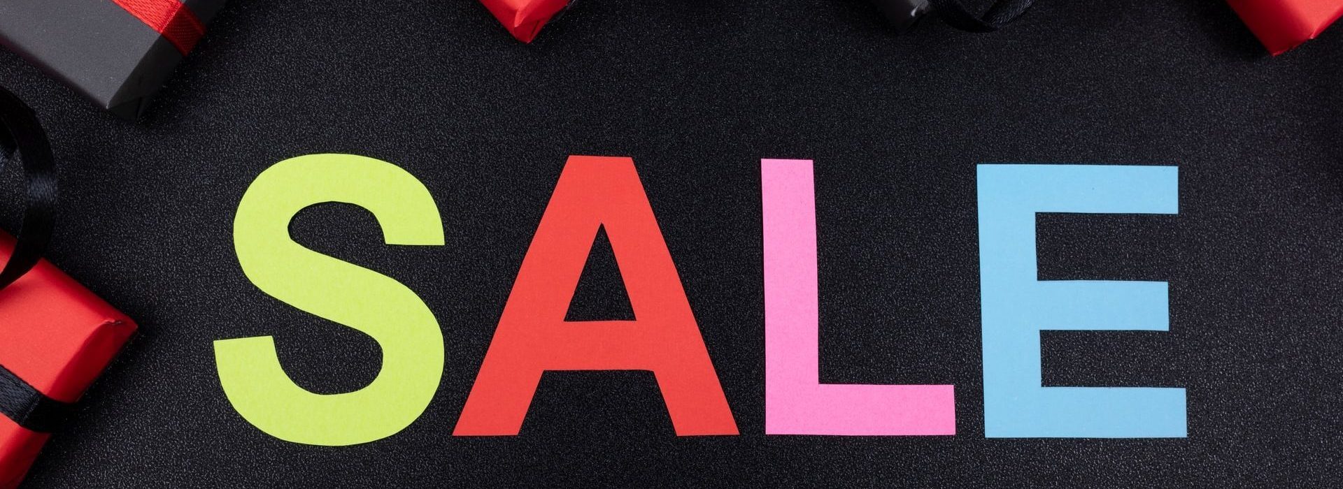 Coloured words on black background that say SALE