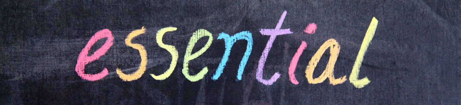 Chalk written colourful word essential