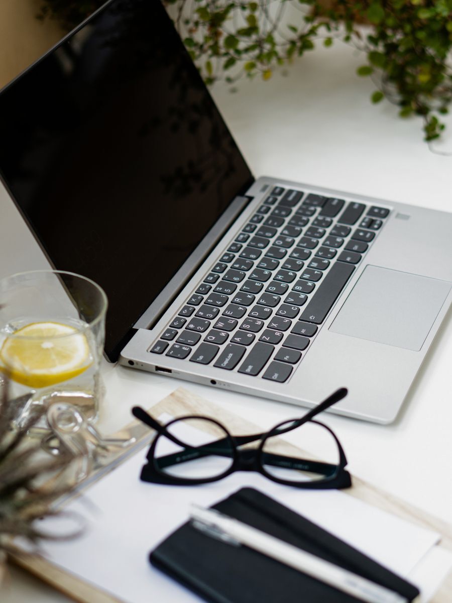 learning how to apply for a federal government job with a laptop, glasses, notepad